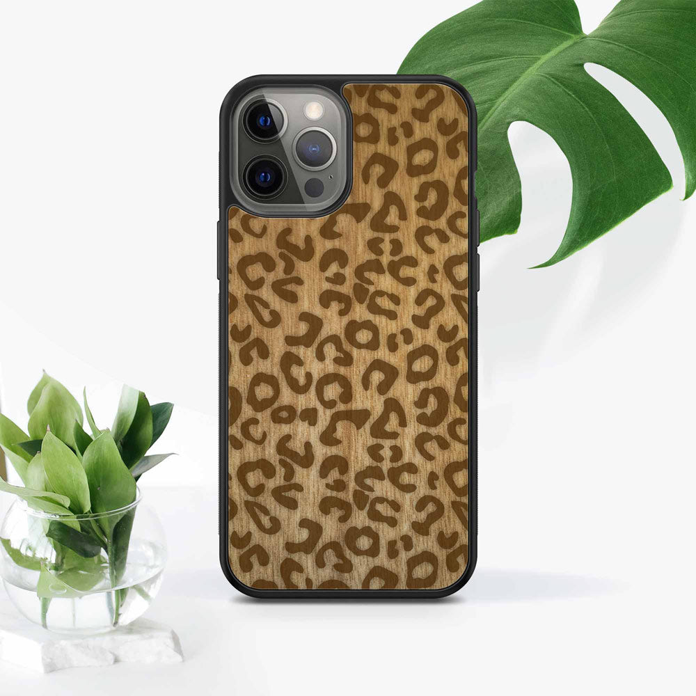 Engrvaed wooden cheetah print phone case on stand