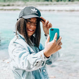 Taking a selfie with the compostable blue phone case