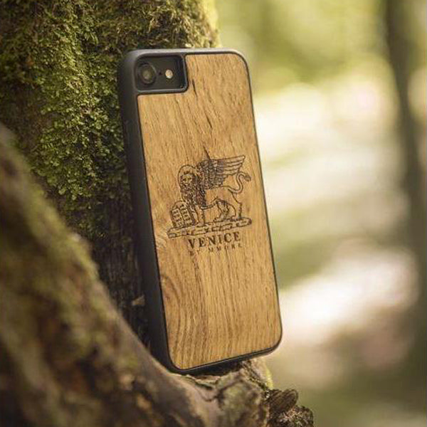 The Venice Lion Phone Case resting on a tree