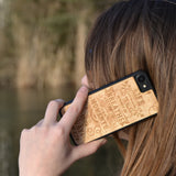 The meaning wooden phone case taking a phone call